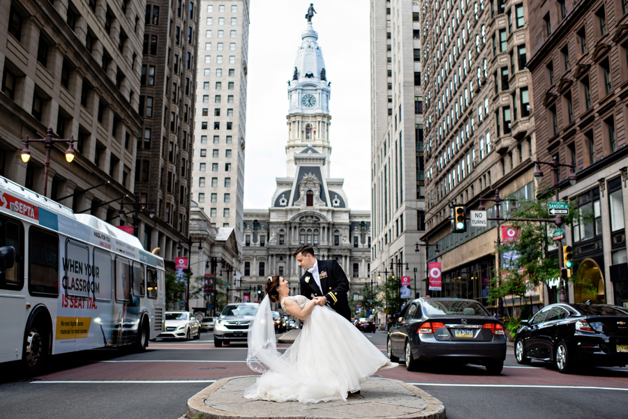 A Navy groom dips his new bride in the center of broad street in Philadelphia.